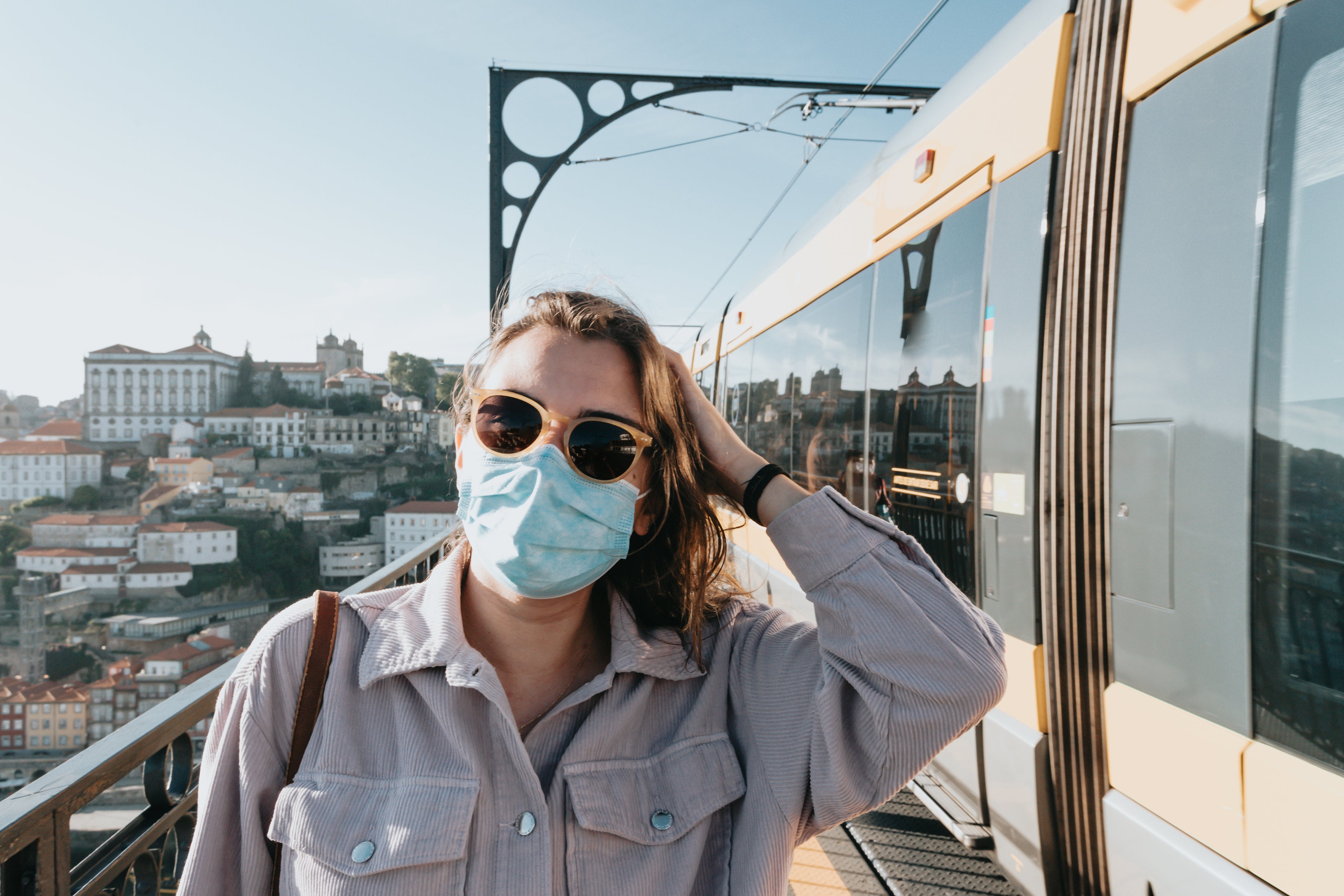 files/person-in-sunglasses-and-a-facemask-stands-by-a-train.jpg